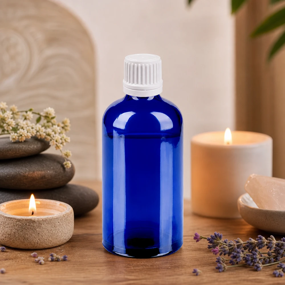 Blå 100 ml glasflaska med vitt dropplock, idealisk för aromaterapi och wellness