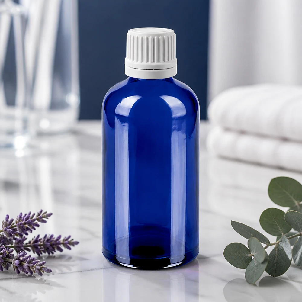 Exakt droppflaska 100 ml av robust blått glas med barnsäkert vitt lock