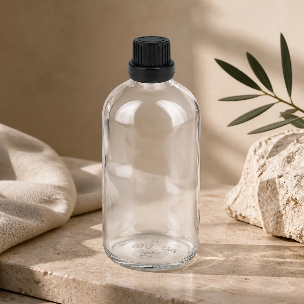 Genomskinlig 100 ml droppflaska i klart glas med svart originalförslutning, serien ClearLine
