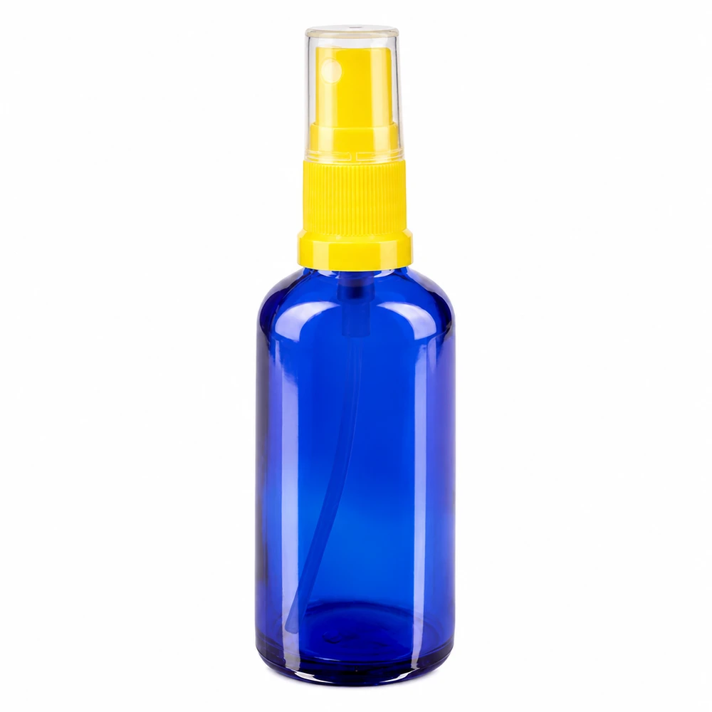 Apoteksflaska blå 50ml med gult sprayfäste 50 ml blå glasflaska med sprayhuvud i gult för apotek och kosmetika