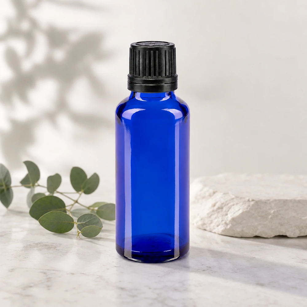Apoteksflaska blå 30ml dropplock med hällring 1mm svart stämpelförslutning Farmaceutisk 30 ml flaska av blått glas med svart skruvlock och droppinsats