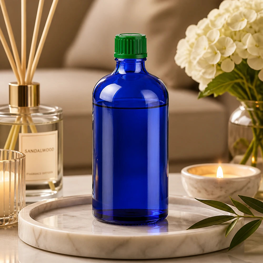 Liten 100 ml glasflaska i elegant koboltblå med praktisk 11 mm skruvgänga